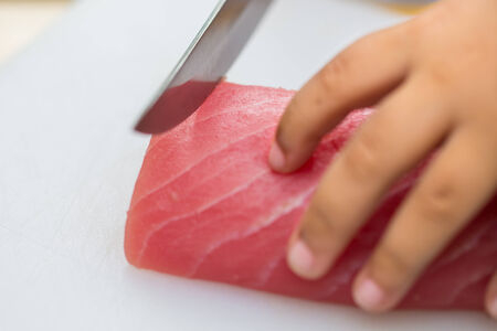 Hand was sliced ââfish to make sushiの写真素材