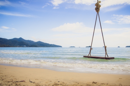 Wooden chairs rest at the beachの写真素材