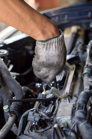 Hands of car mechanic in auto repair serviceの写真素材