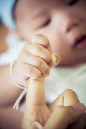 baby hand holding Rough fingerの写真素材