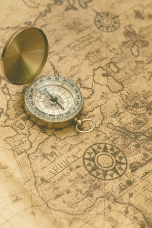 Old compass on vintage map.