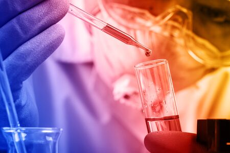 Hands of clinician holding tools during scientific experiment in laboratoryの写真素材