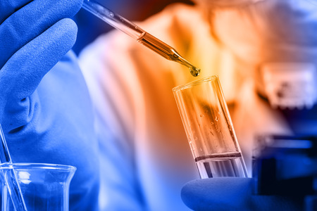 Hands of clinician holding tools during scientific experiment in laboratoryの写真素材