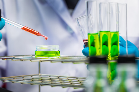 Hands of clinician holding tools during scientific experiment in laboratoryの写真素材