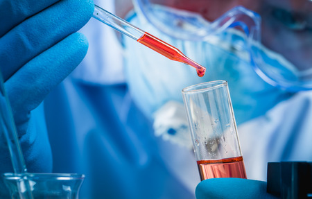 Hands of clinician holding tools during scientific experiment in laboratoryの写真素材