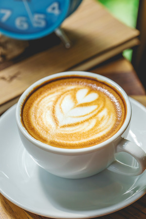 Coffee on a table showing break or breakfast in coffee shop or office,late art