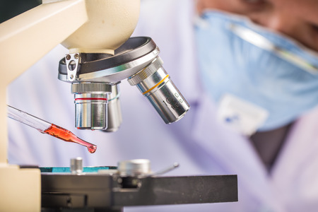 Hands of clinician holding tools during scientific experiment in laboratoryの写真素材