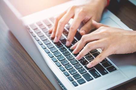 Female office worker typing on the keyboard