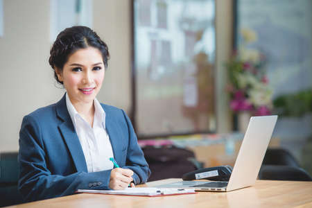 Businesswoman in office working with labtopの写真素材