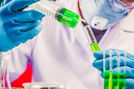 Hands of clinician holding tools during scientific experiment in laboratory,MERS