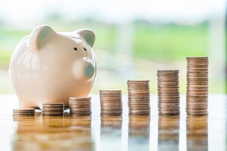 Saving money concept preset by Male hand putting money coin stack growing businessの写真素材