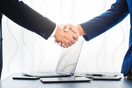 business concept, businessman handshake in office workspace for investmentの写真素材