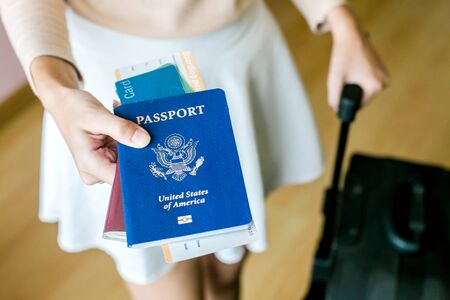 Closeup of girl holding passports and boarding passの写真素材