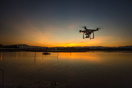 copter drone flying at sunsetの写真素材