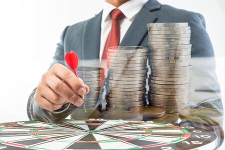 Business Man hand holding a target with darts hitting the center over white background. Concept of personal coaching successの写真素材