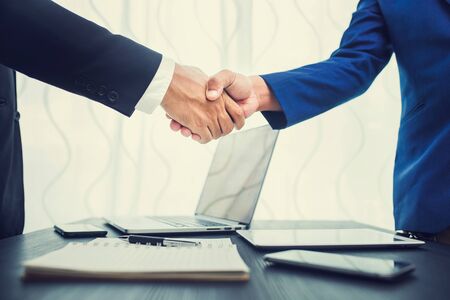 business concept, businessman handshake in office workspace for investmentの写真素材