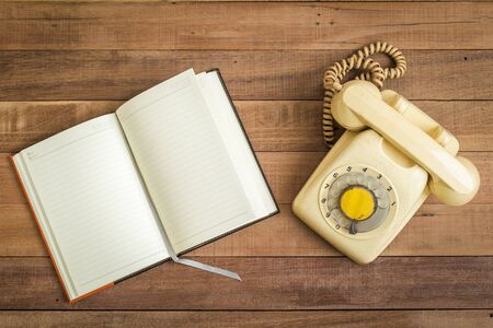 Top view of Notebook andOld telephone,Retro,vintage telephoneの写真素材