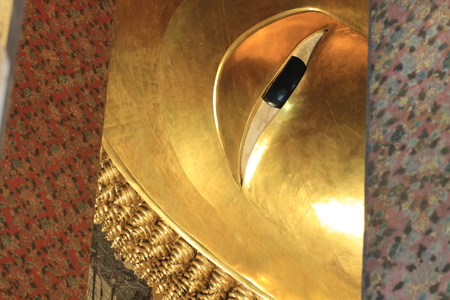 Close up the face of big golden reclining budhha statue in Wat Pho,Bangkok Thailandのeditorial素材