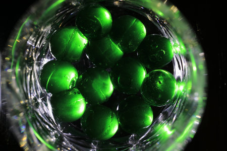 Close up transparency colorful jelly balls on small glass dish on black backgroundの写真素材