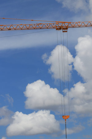 The construction crane and white clouds blue skyの写真素材