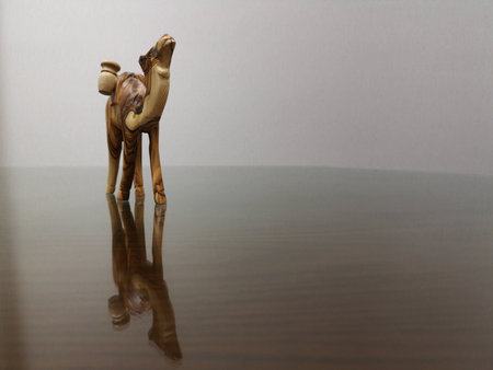 Close up wood camel carving and reflection on the groundの写真素材