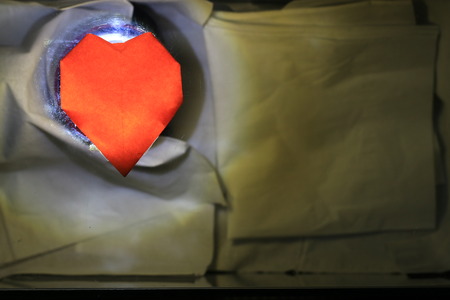 Close up transparency orange paper heart on white backgroundの写真素材