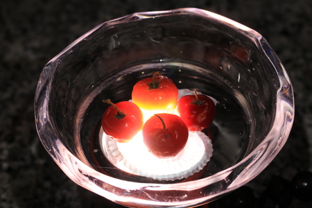 Close up transparency red cherries on glass cupの写真素材