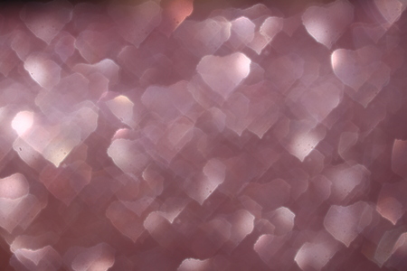 Close up white heart bokeh on purple background