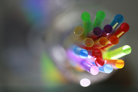 Close up top view of colorful straw in crystal glassの写真素材