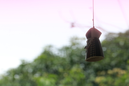 Close up small hanging doll on white and green backgroundの写真素材