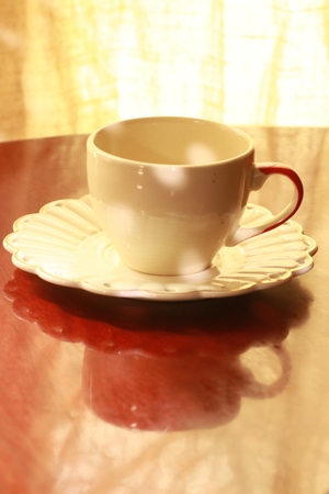The  light and shadow on coffee cup and reflection on the wood tableの写真素材