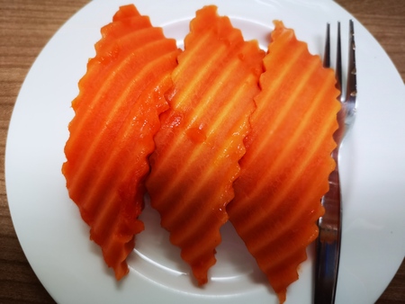 Top view papaya fruit pieces on white ceramic dishの写真素材