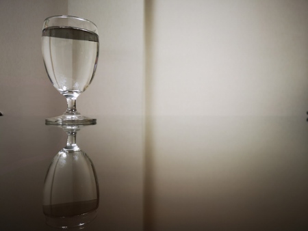 Drinking water and reflection on glass table