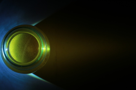 Top view of transparent honey bee in small glass cup on black backgroundの写真素材