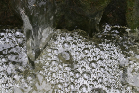 Close up bubbles water of small waterfallの写真素材