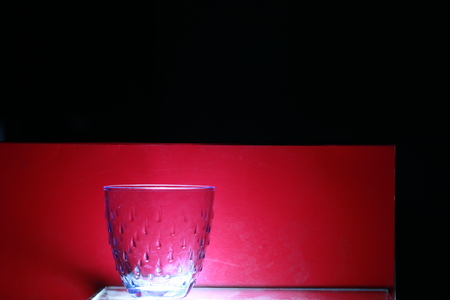 Transparency crystal glass on red and black backgroundの写真素材