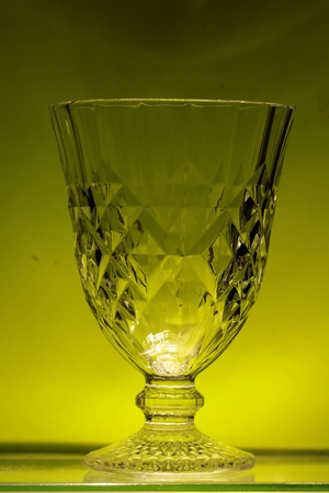 Transparency crystal glass on yellow backgroundの写真素材