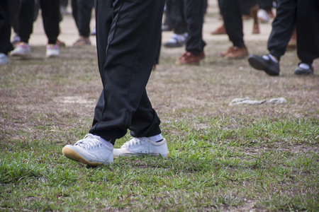 Children wear gym shoes on the field.