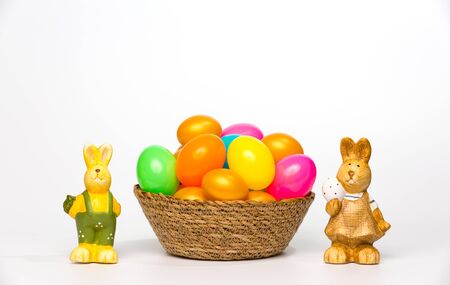 easter eggs in a basket on white background
