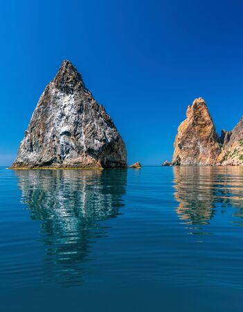 view on coastal cliffs, rock Orest and Pilad, cape Fiolent in Balaklava, Sevastopol Crimea. Bright sunny day, calm cristal clear blue sea. The concept of calmness silence and unity with natureの写真素材