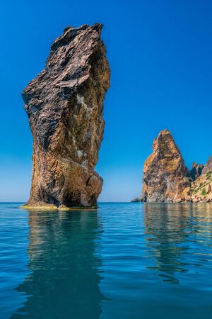 view on coastal cliffs, rock Orest and Pilad, cape Fiolent in Balaklava, Sevastopol Crimea. Bright sunny day, calm cristal clear blue sea. The concept of calmness silence and unity with natureの写真素材