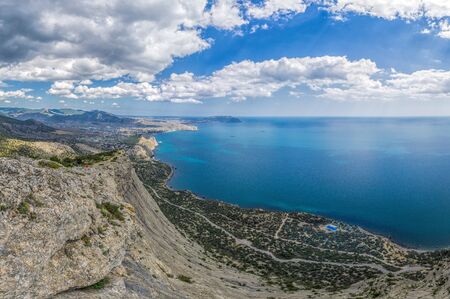 Scenic high angle view towards Sudak resort town, Fortress from the top of Falcon Mountain,...