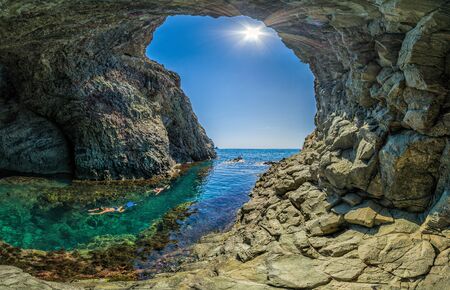 girl dive in the Dianas grotto Sevastopol. Fiolent, Crimea on a background of rocky shores. The concept of an travel, relax, active and healthy life in harmony with nature.の写真素材