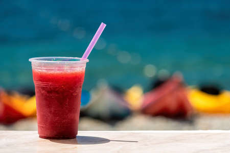 summer chilled juice and kayaks rental place on the beach. Surfboards, different kayaks on the beach, water sport, happy active summer vacation. Row of kayaks ready to rent.の写真素材