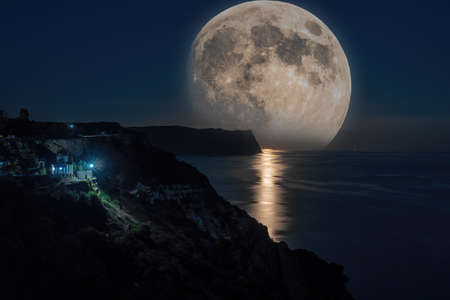 Starry night with a full moon over sea, cape Fiolent. Jasper beach and rock of the holy phenomenon...