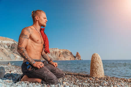 Mature Man Holding Sword Ready To Fight - Portrait Of A Handsome Muscular Ancient Warrior With A Swordの写真素材
