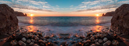 Bright sea sunset nature abstract background banner. The waves crash into the rock, lit by the warm...