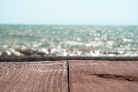 Abstract nature summer or spring ocean sea background. Small waves on golden warm water surface in motion blur with bokeh lights from sunset. Holiday, vacation and recreational background conceptの写真素材