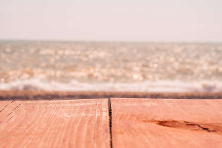 Abstract nature summer or spring ocean sea background. Small waves on golden warm water surface in motion blur with bokeh lights from sunset. Holiday, vacation and recreational background conceptの写真素材