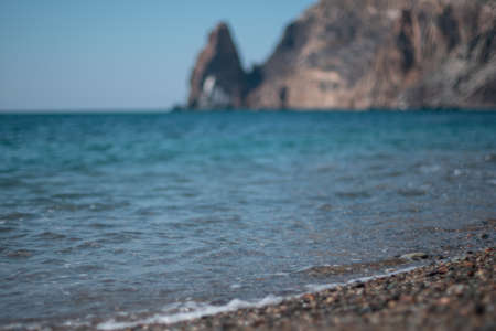 Abstract nature summer ocean sunset sea background. Small waves on water surface in motion blur with...